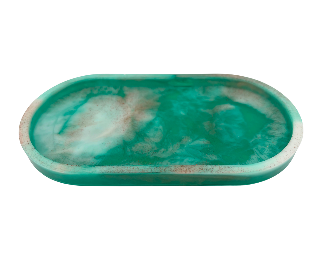 An oval resin tray with a marbled teal, green, and white pattern, isolated on a white background.