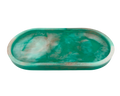 An oval resin tray with a marbled teal, green, and white pattern, isolated on a white background.