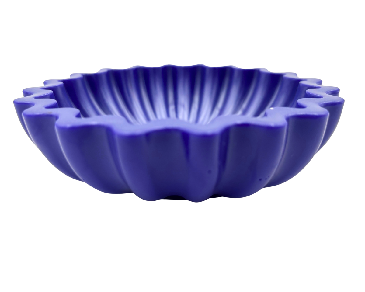 A small, scalloped ceramic bowl in a deep periwinkle, shown from a front-facing perspective on a plain white background.