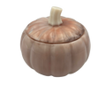 A small decorative lidded container shaped like a pumpkin, with a ribbed rounded body, a lid that fits on top, and a short faux stem, shown on a plain white background.