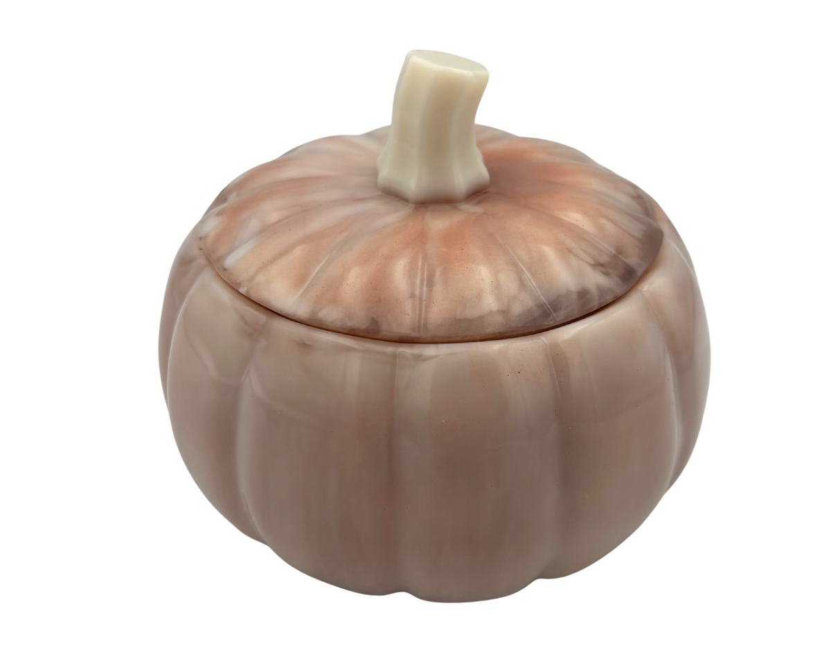 A small decorative lidded container shaped like a pumpkin, with a ribbed rounded body, a lid that fits on top, and a short faux stem, shown on a plain white background.