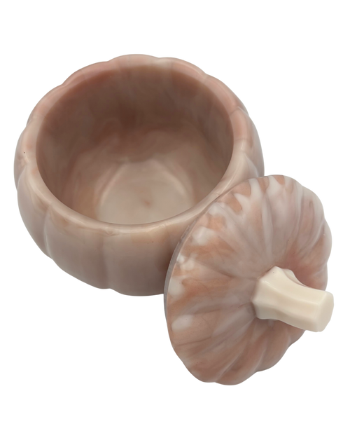 A small pumpkin-shaped ceramic container with a matching lid, shown on a plain white background. The container and lid have a warm, marbled blush pink and beige coloration with a cream-colored stem detail on the lid.
