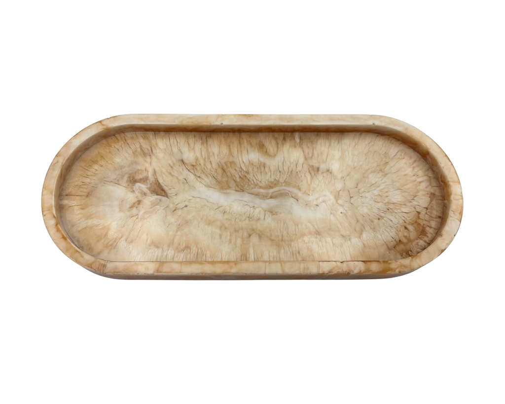 oval shallow resin tray with marbled beige and white patterns on a white background
