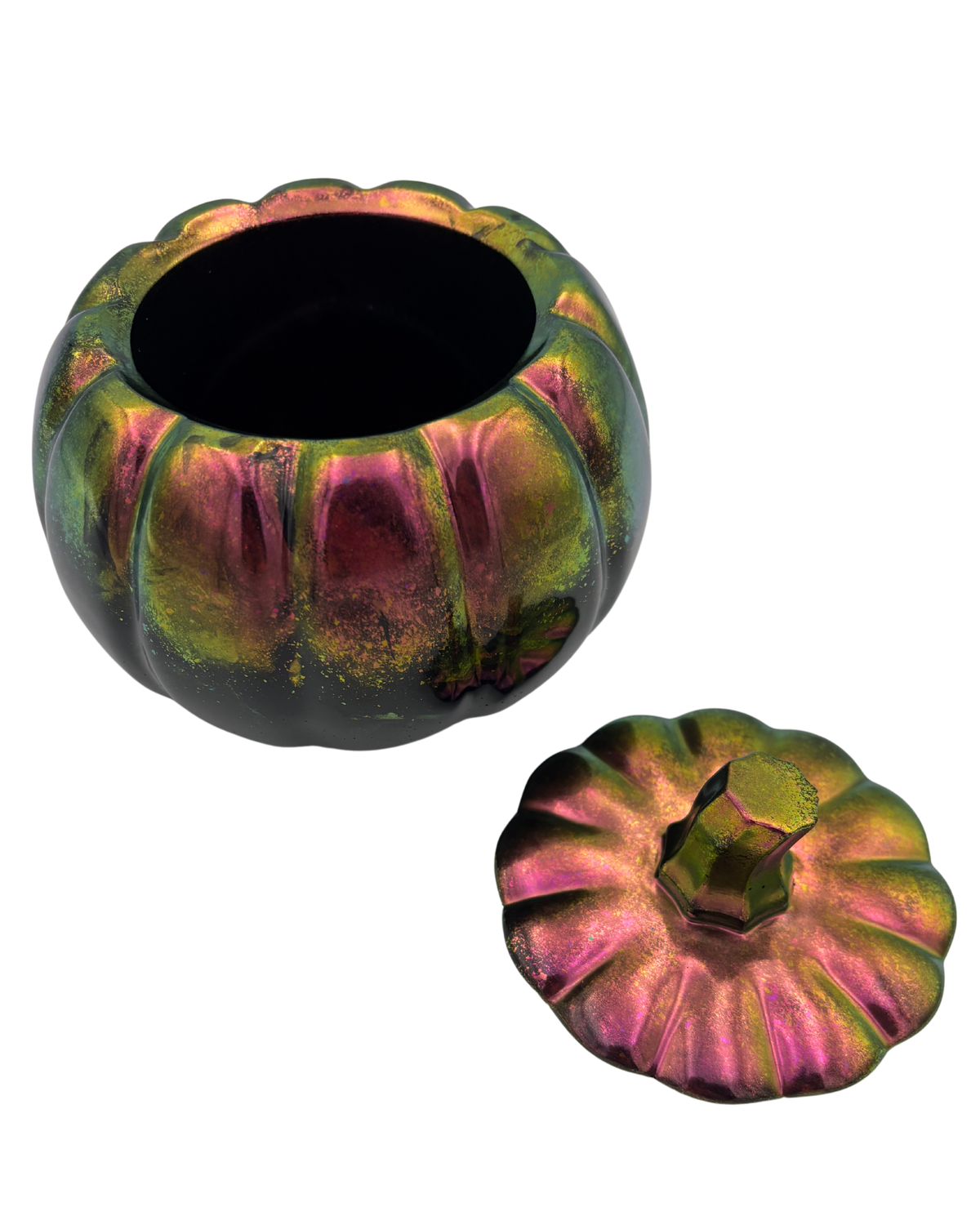An iridescent resin pumpkin-shaped container with its lid placed beside it, set against a plain white background.
