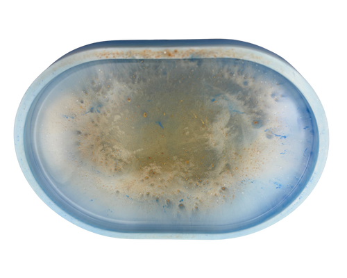 an oval resin tray with blue, white, and gold features on a white background