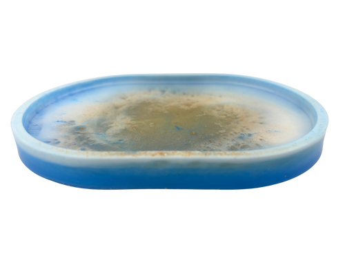 an oval resin tray with blue, white, and gold features on a white background