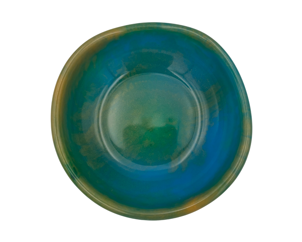 A round resin bowl with a marbled glaze transitioning from deep teal-blue to green and brown, shown from a top-down view on a white background.