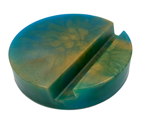 circular resin phone holder with blue, green, and gold swirls on white background