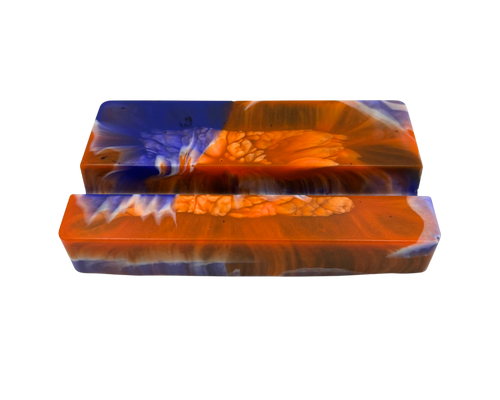 A mobile phone stand, featuring a marbled pattern of vibrant orange, deep blue, and white swirls with a textured bubbly finish.