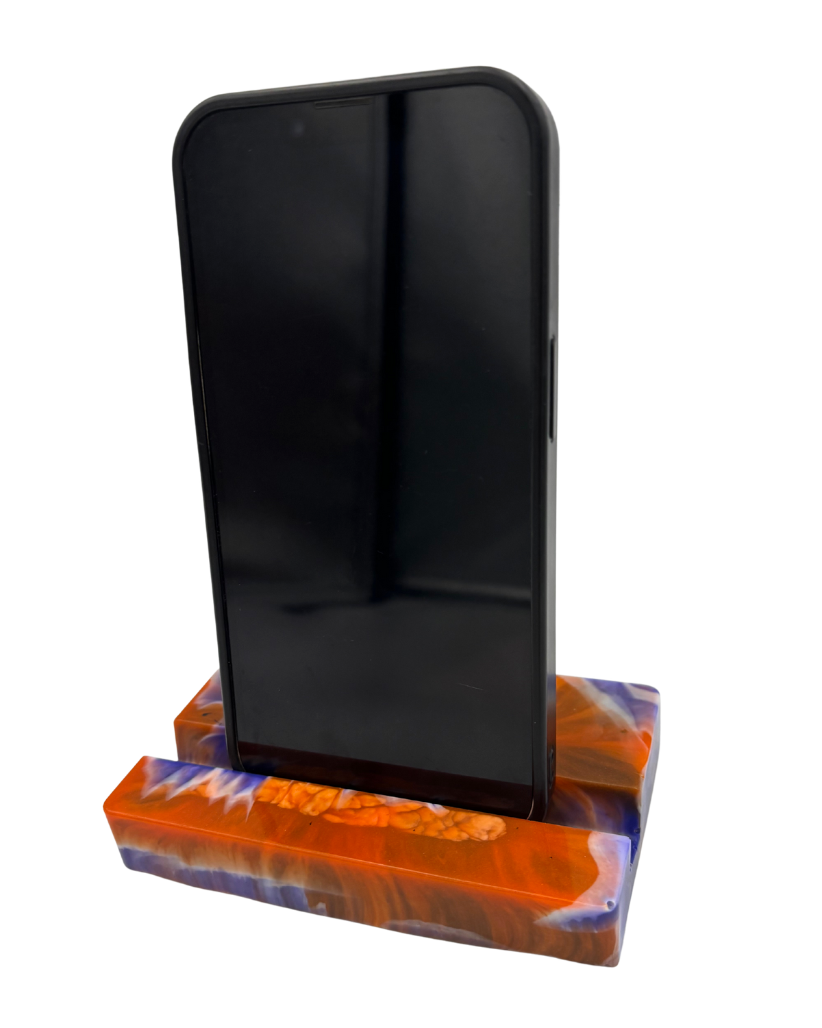 A mobile phone stand, featuring a marbled pattern of vibrant orange, deep blue, and white swirls with a textured bubbly finish.