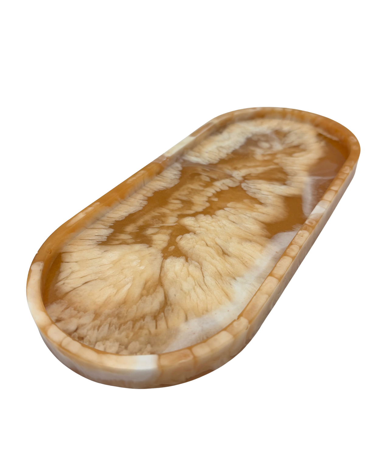 An oval resin tray with a swirling agate-like pattern in shades of brown, tan, and cream, isolated on a white background.