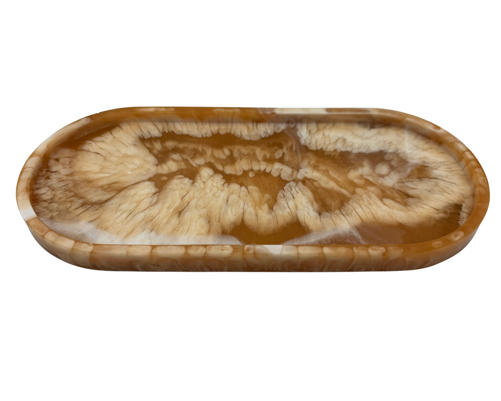 An oval resin tray with a swirling agate-like pattern in shades of brown, tan, and cream, isolated on a white background.