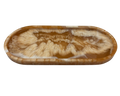 An oval resin tray with a swirling agate-like pattern in shades of brown, tan, and cream, isolated on a white background.