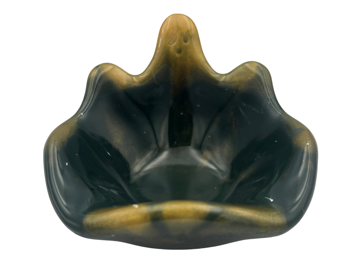 A small decorative bowl with a wavy, ghost silhouette, featuring a glossy dark green to black marbled finish with prominent golden-yellow veining and highlights, set against a plain white background.