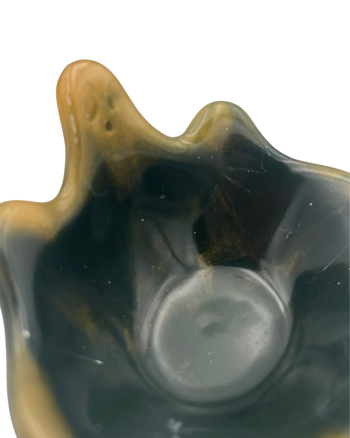 A small decorative bowl with a wavy, ghost silhouette, featuring a glossy dark green to black marbled finish with prominent golden-yellow veining and highlights, set against a plain white background.