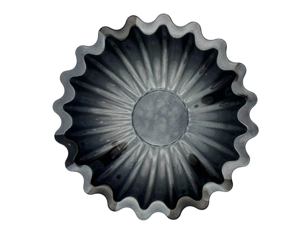 Gray and black resin bowl with scalloped edges