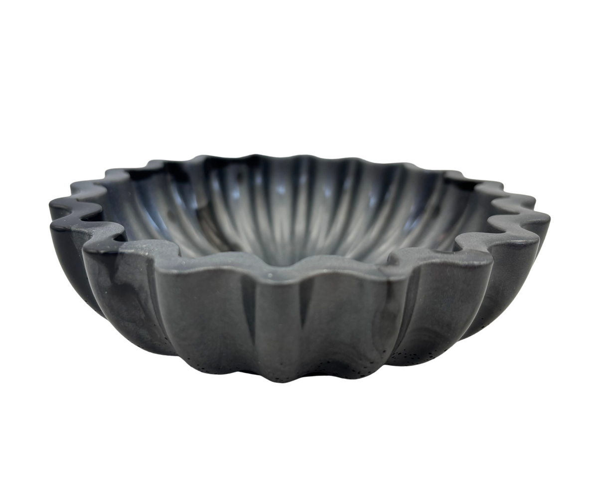 Gray and black resin bowl with scalloped edges