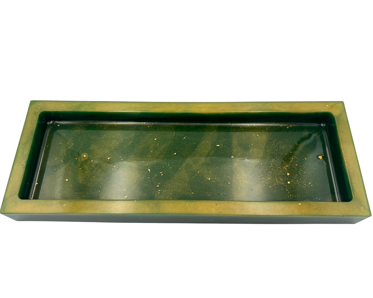 A rectangular resin tray with a thick gold-toned border and a dark green base with gold flecks shown on a plain white background.