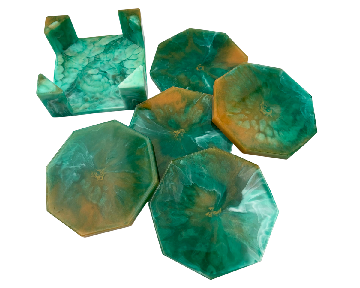 A set of octagonal resin coasters and a matching octagonal tray with a raised rim, featuring a marbled swirl pattern of green, teal, and amber-orange resin on a plain white background.