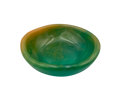 A small, shallow oval dish or bowl made of green resin with a warm amber-orange tint along the upper left edge, shown on a plain white background.