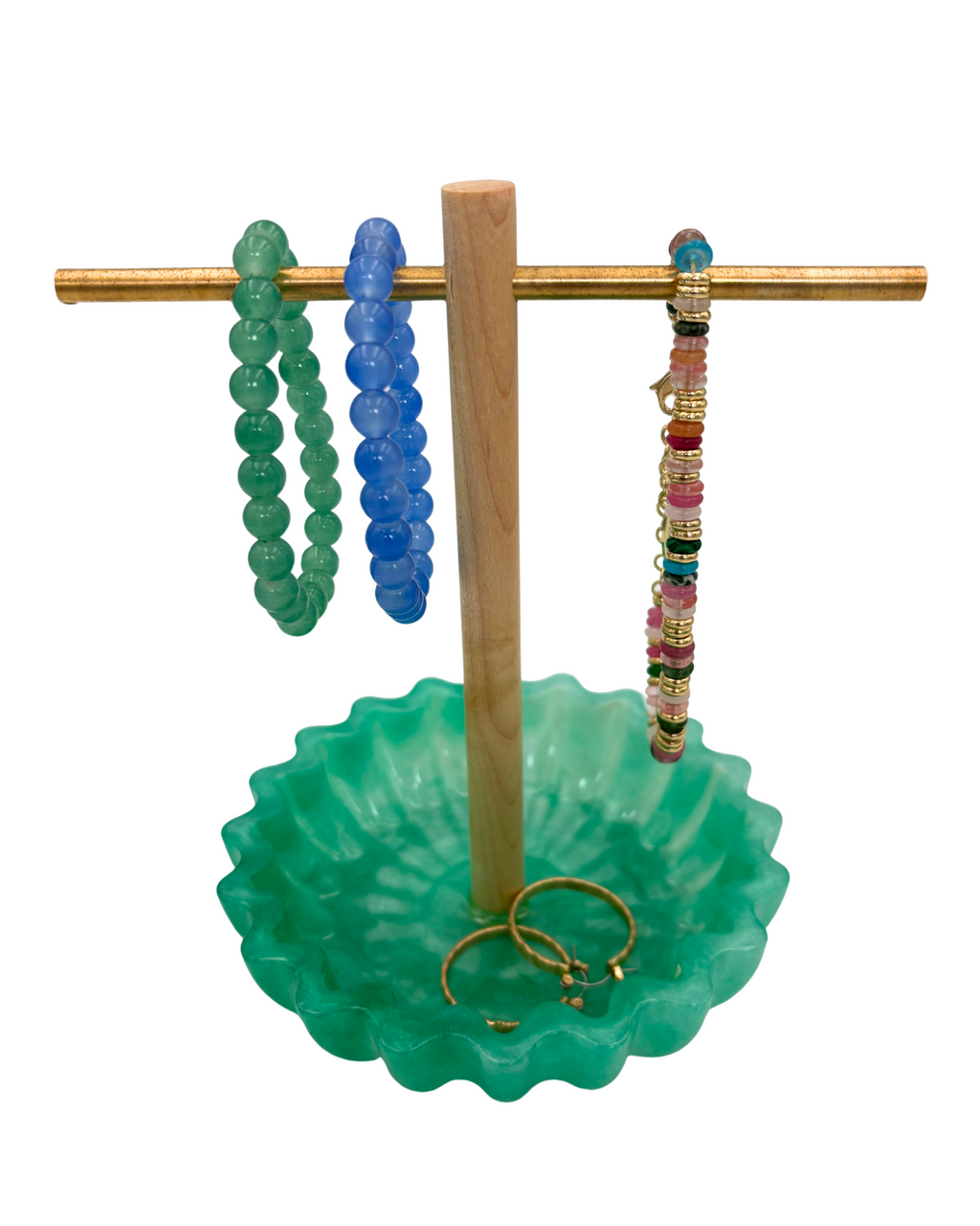 Green resin tray with wooden and brass jewelry holder with bracelets and earrings