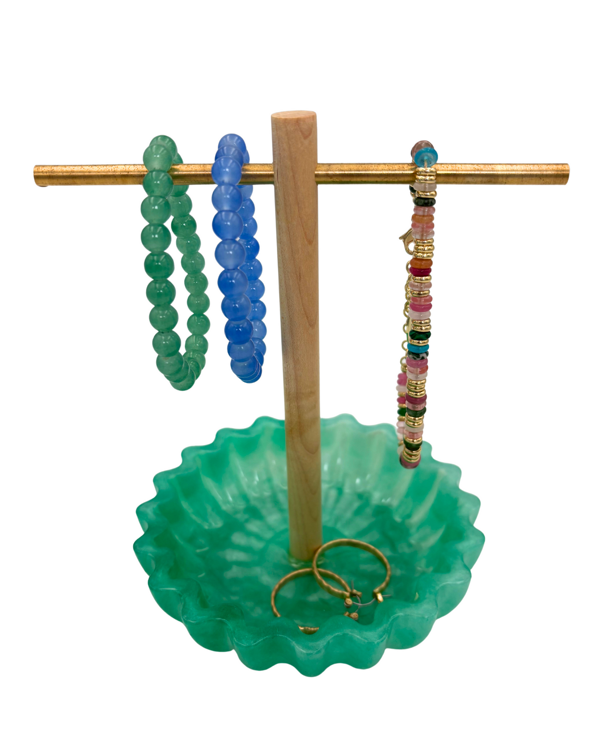 Green resin tray with wooden and brass jewelry holder with bracelets and earrings