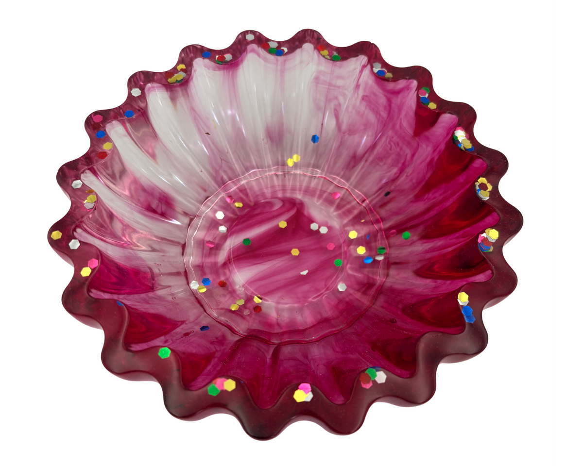 magenta resin bowl with confetti glitter and scalloped edges