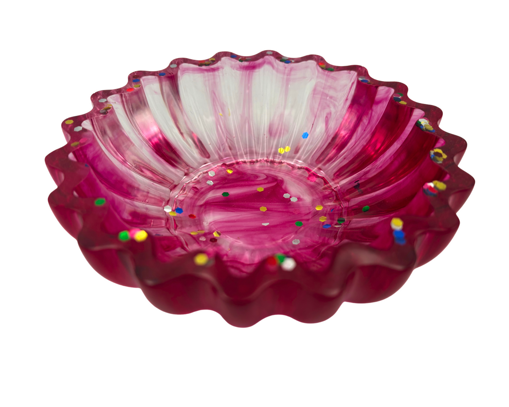 magenta resin bowl with confetti glitter and scalloped edges