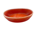 A small, shallow oval dish with orange swirls and a light rim, isolated on a white background.