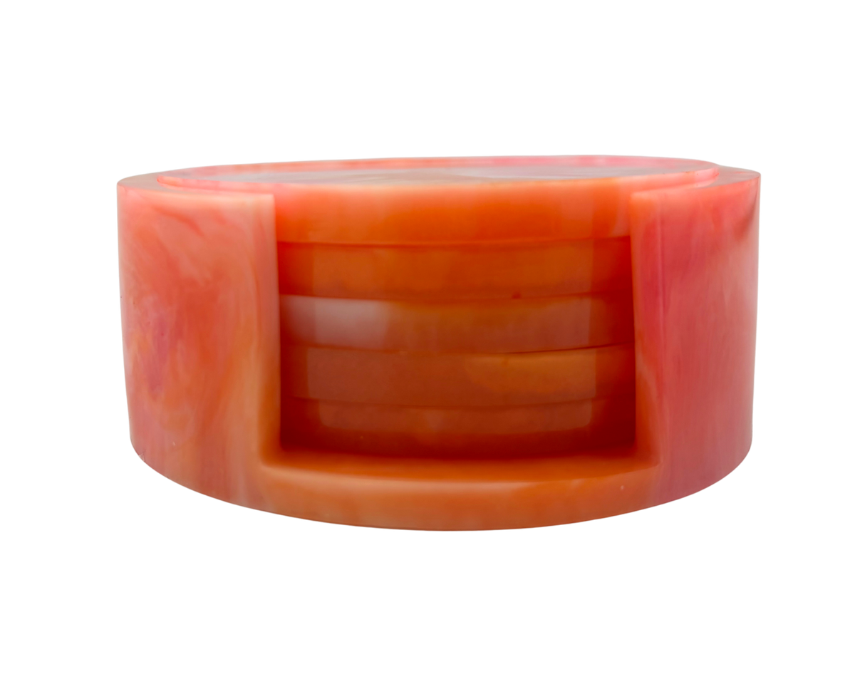 Set of resin coasters with holder; pink, orange, and white swirl pattern on a white background