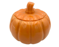 An orange pumpkin-shaped resin container with a matching lid and a short stem, shown on a plain white background.