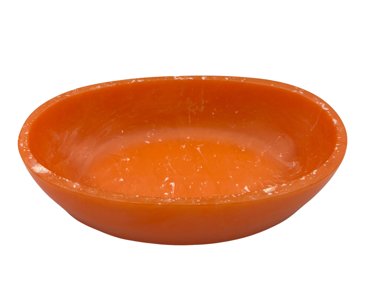 An orange resin bowl with a shallow depth, shown from a top-down perspective on a solid white background.