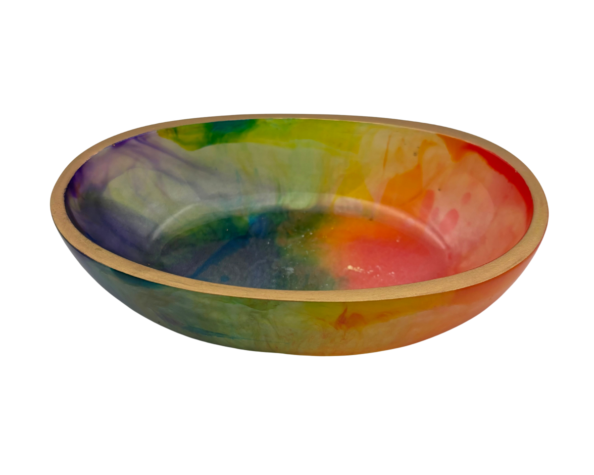 A shallow oval bowl with a colorful tie-dye pattern in shades of purple, green, yellow, orange, and red, finished with a gold rim, shown on a plain white background.