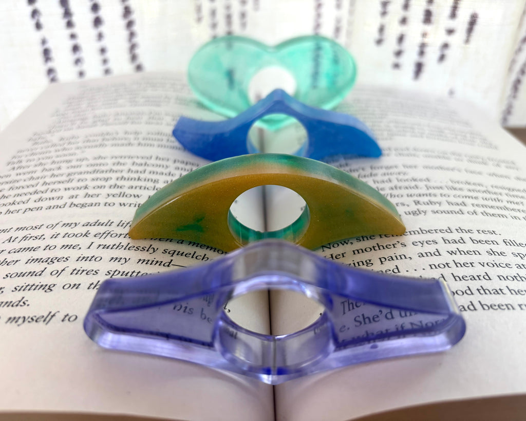 Resin page holders in various shades of green and blue