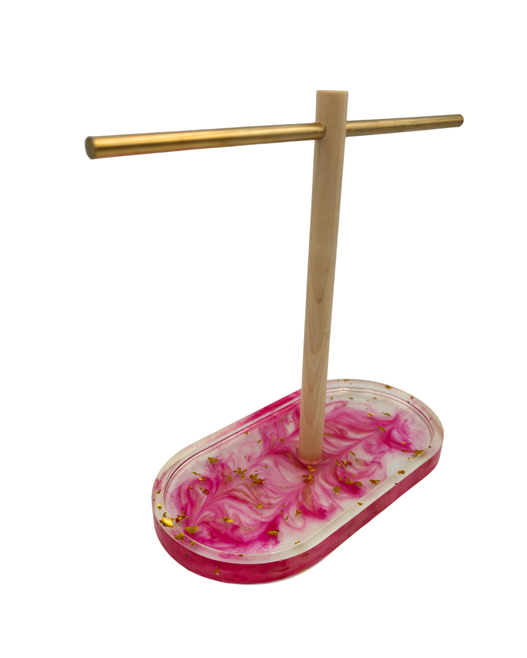 A jewelry display stand with a natural wood T-shaped crossbar and a pink and white marbled resin oval base containing small gold leaf flakes, shown on a plain white background.