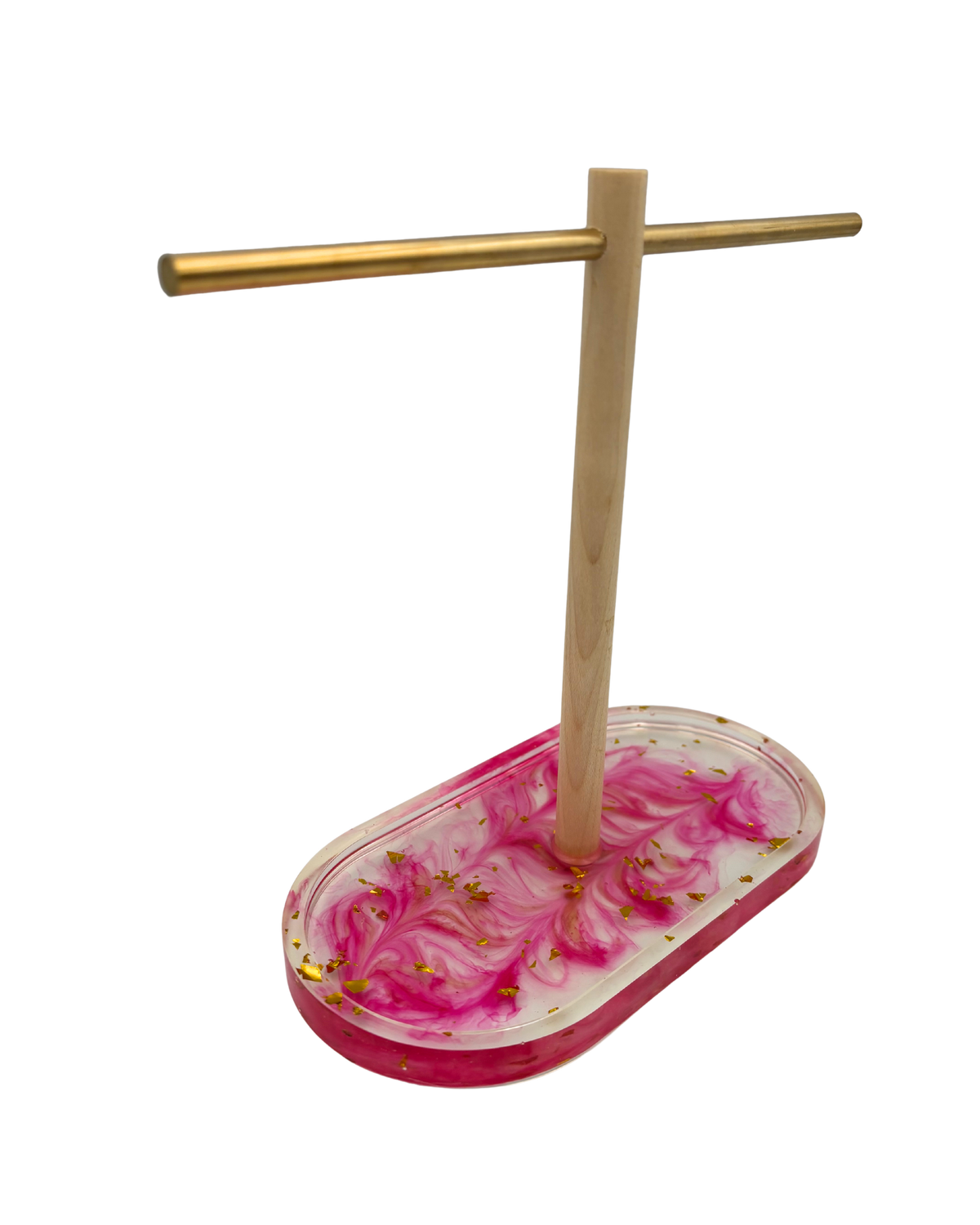 A jewelry display stand with a natural wood T-shaped crossbar and a pink and white marbled resin oval base containing small gold leaf flakes, shown on a plain white background.