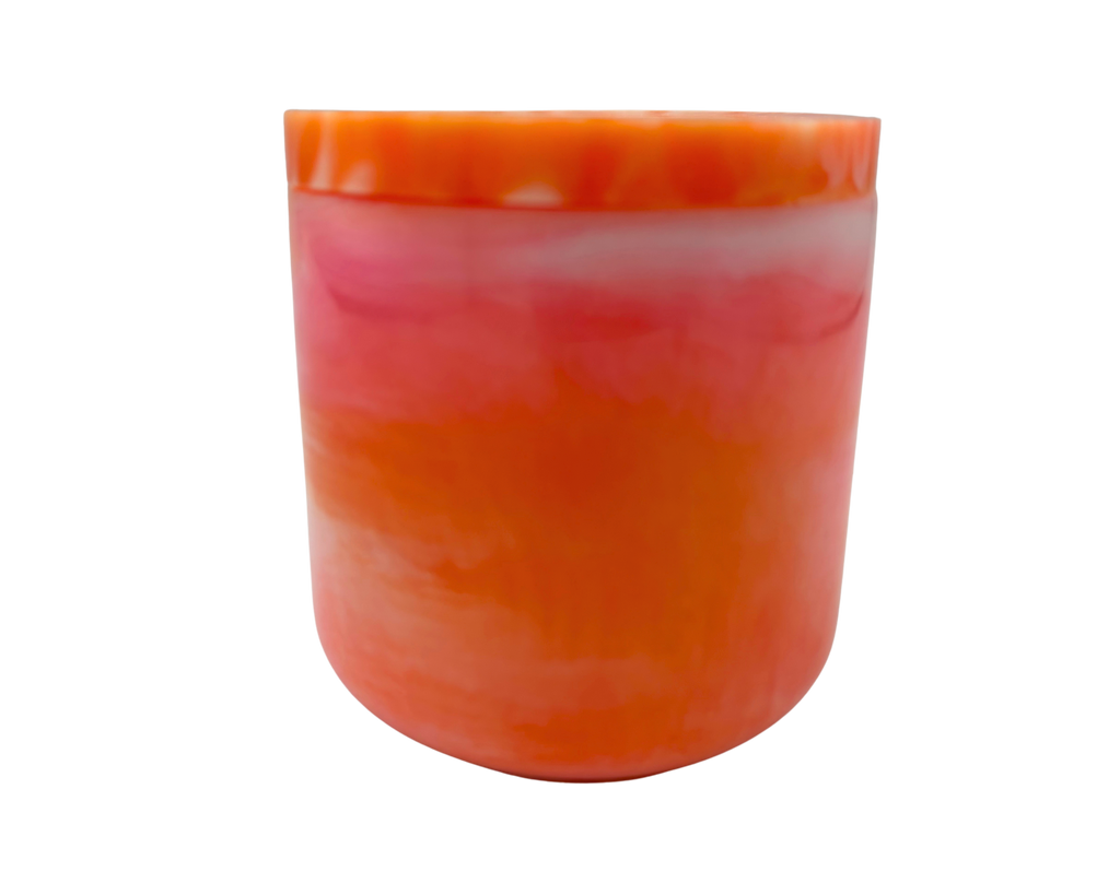 A cylindrical container with a lid, featuring a marbled design of vibrant orange, pink, and white layers, isolated on a white background.