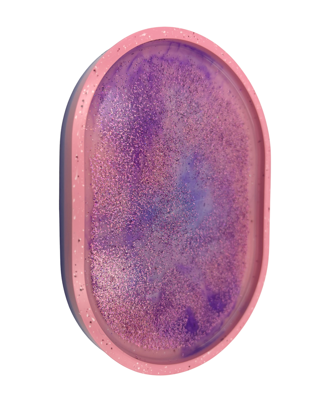 An oval-shaped pink tray or mold containing a purple glittery resin surface, shown against a plain white background.