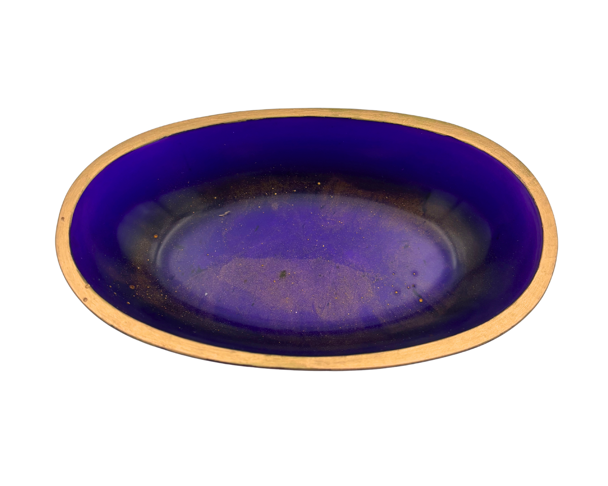 An oval resin dish with a deep purple and gold flecked interior and a metallic gold rim, shown against a plain white background.