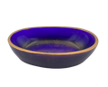 An oval resin dish with a deep purple and gold flecked interior and a metallic gold rim, shown against a plain white background.