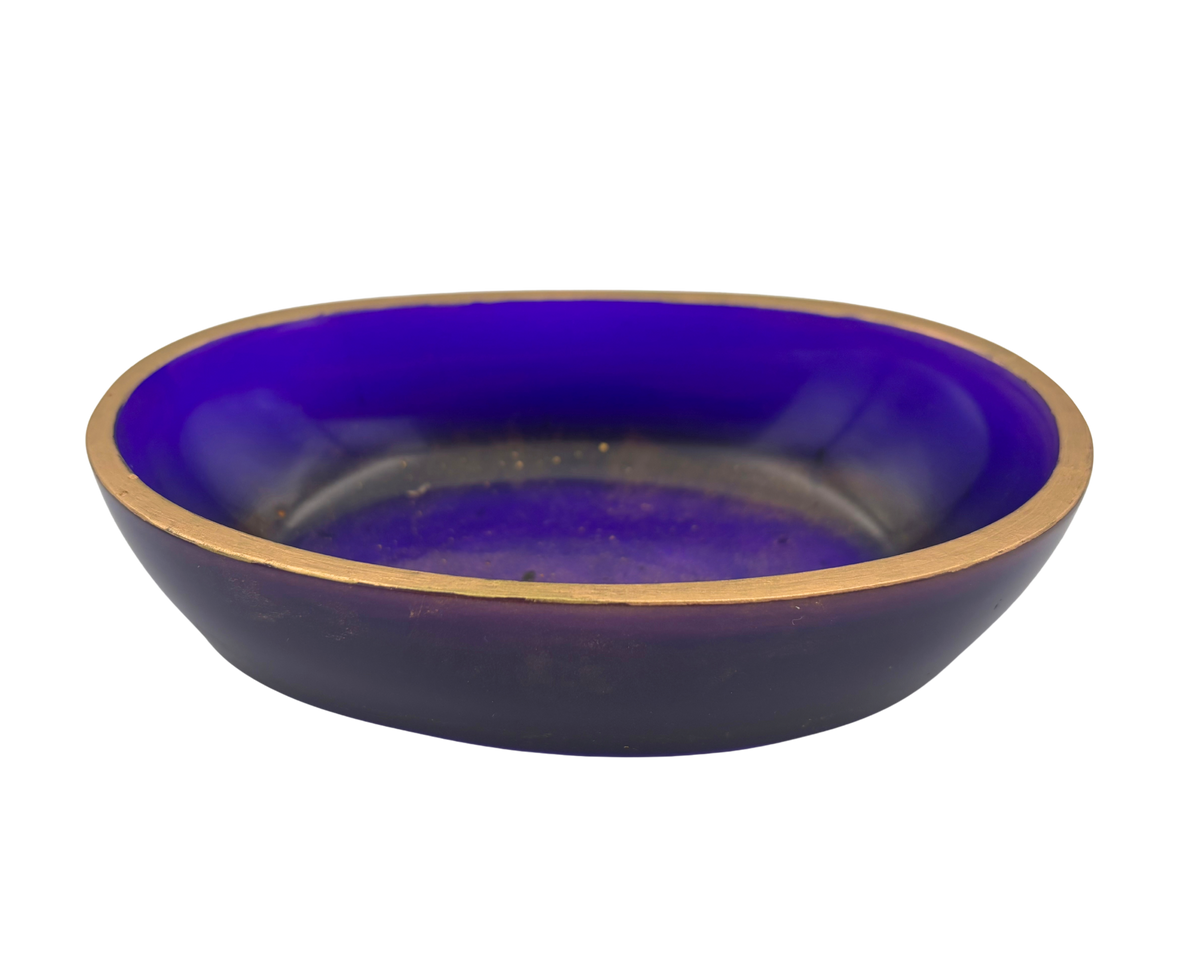 An oval resin dish with a deep purple and gold flecked interior and a metallic gold rim, shown against a plain white background.
