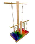 Jewelry stand with colorful base and hanging necklaces on a white background