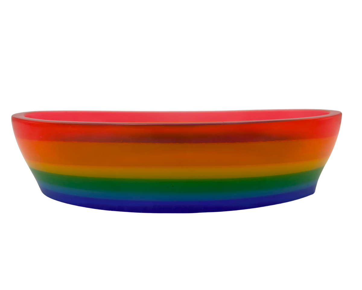 A shallow oval resin bowl with a vibrant rainbow gradient design, featuring concentric bands of red, orange, yellow, green, blue, and purple on a plain white background.