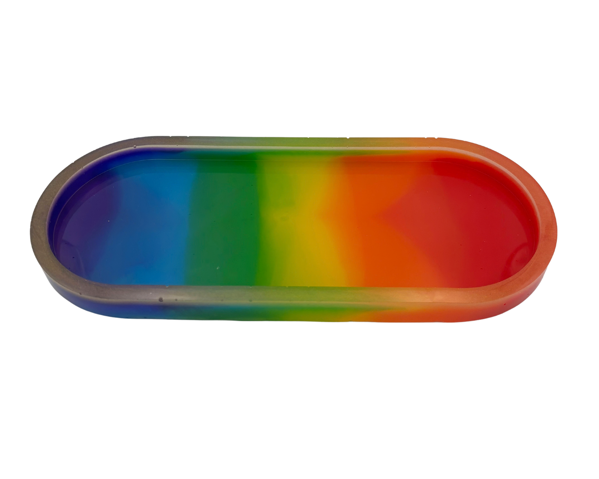 An oval-shaped resin tray with a translucent clear plastic rim and a vibrant rainbow gradient pattern, shown on a plain white background.