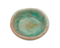 a small ring dish made of resin with teal and beige swirls on a white background
