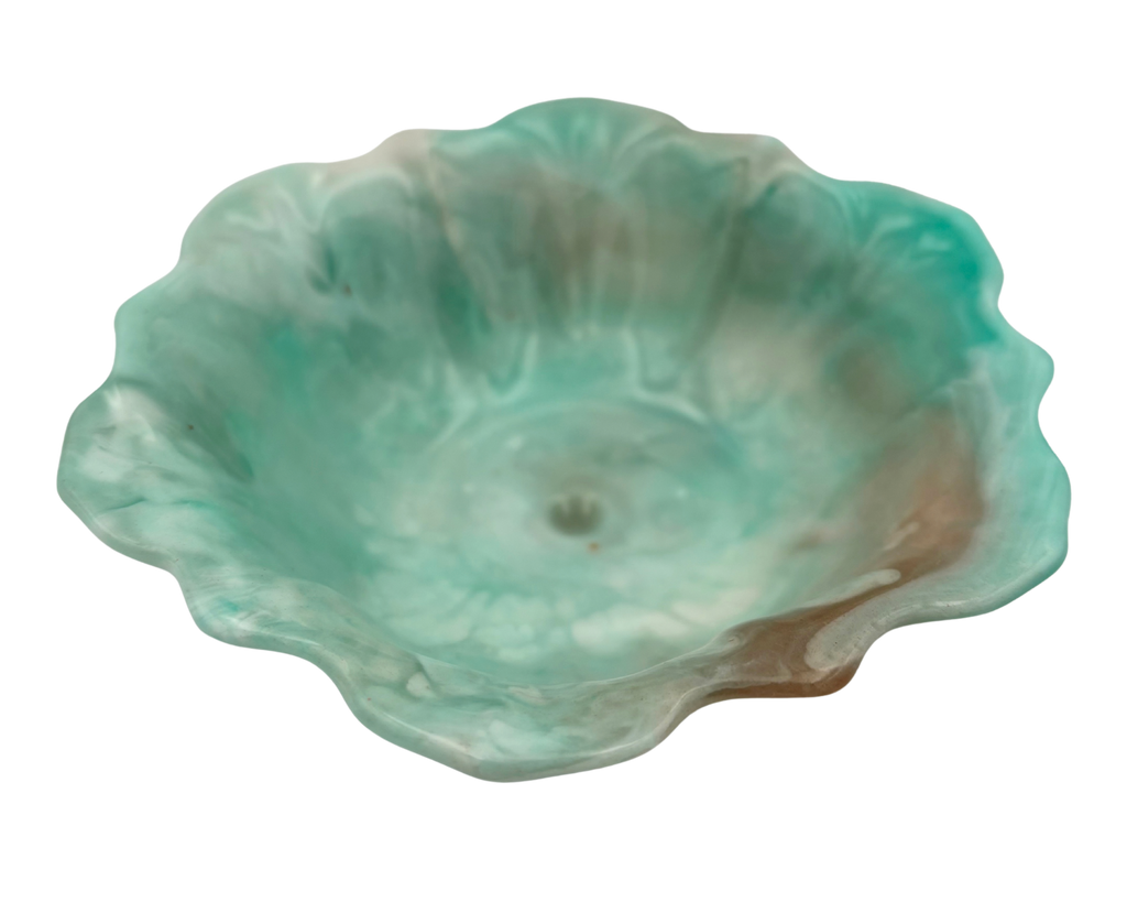 A handmade resin bowl with petal-shaped rim, featuring a marbled swirl of mint green, teal, white, and subtle peach-brown tones, isolated on a white background.