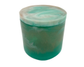 A cylindrical resin jar with a marbled green and white design, featuring a solid teal-green base and a swirled white and light teal lid.