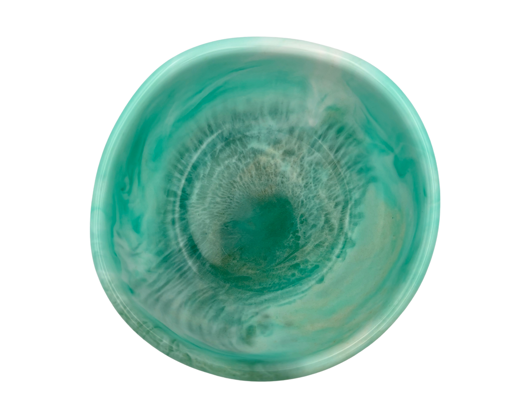 A round resin bowl with a swirling teal and mint green finish, shown from a top-down perspective on a solid white background.