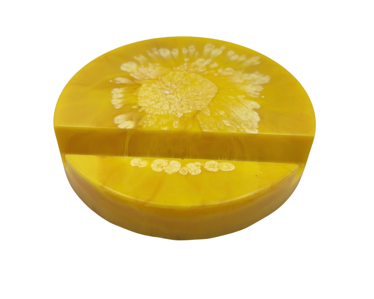 yellow circular resin phone stand on a white background