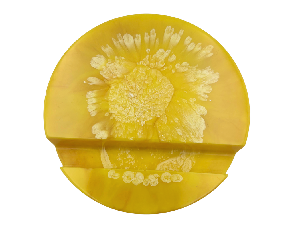 yellow circular resin phone stand on a white background